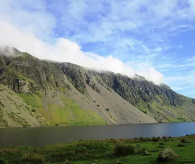 a mountain with a lake in front of it at THE OLD FARMHOUSE in Holmrook