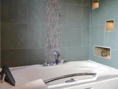 a bathroom with a bath tub with a sink at West Fells Cottage in Arlecdon