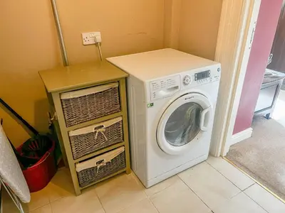 a washer and dryer in a small room at Geltsdale Garden Apartment ground floor home in Wetheral close to Carlisle & Ullswater in Wetheral