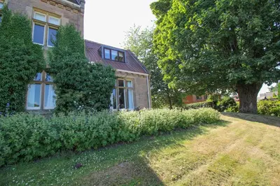 a brick house with a tree next to a yard at Geltsdale Garden Apartment ground floor home in Wetheral close to Carlisle & Ullswater in Wetheral