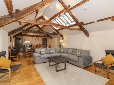 a living room with a couch and a table at Low Melbecks House in Keswick