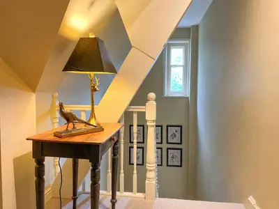 a lamp on a table next to a stairway at Geltsdale East Wing sleeps 6 with River Eden views near Carlisle & Ullswater in Wetheral
