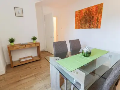a dining room with a glass table and chairs at 1 Alpine Place in Thornhill