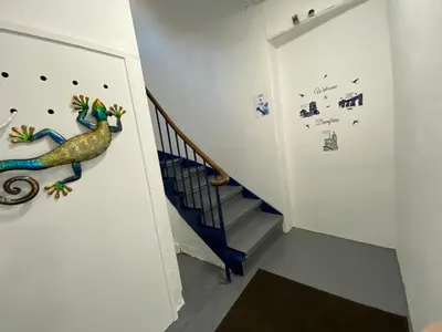 a staircase with a painting of a dinosaur on the wall at Stylish 2nd Floor Georgian Period Flat in Dumfries