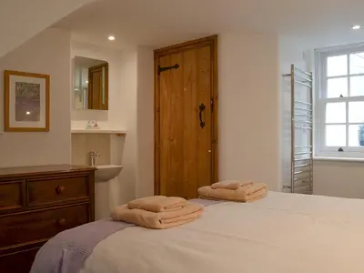 a bedroom with a bed with two towels on it at Apple Barn in Applethwaite