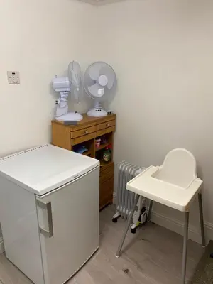 a laundry room with a hair dryer and a table at Kezbah 1, 22 the square centre of Dalston village in Dalston