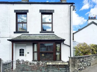 a white house with three windows on top of it at Apple Cross in Keswick