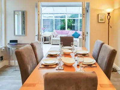 a dining room with a table and chairs and a table and chairsktop at Apple Cross in Keswick