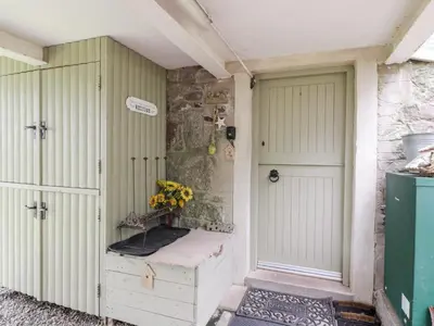 a room with two doors and a vase of yellow flowers at The Barn in Dalbeattie