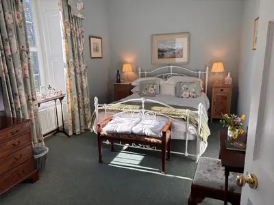 a bedroom with a bed and a window at Applegarth House in Lockerbie