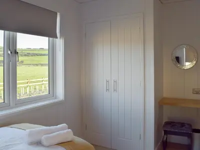 a bedroom with a bed and a window at Cree Lodge - Uk13636 in Creetown