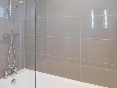 a shower with a glass door and a bath tub at Cree Lodge - Uk13636 in Creetown