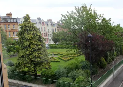 a view of a garden from a balcony at Ashfield Guesthouse in Douglas