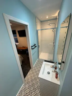 a bathroom with a white sink and a shower at Ashfield Guesthouse in Douglas