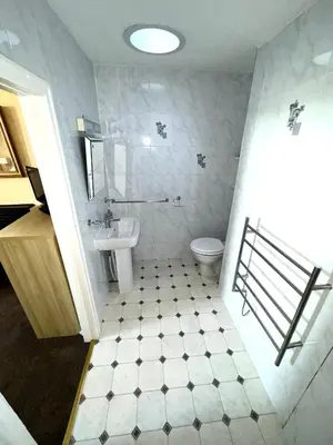 a bathroom with a toilet and a sink at Ashfield Guesthouse in Douglas
