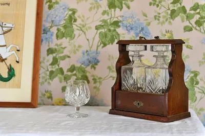 a table with a wine glass and a bottle and a glass at Finest Retreats - Edwardian Country House - 9 Bed, Sleeping up to 21 in Longtown