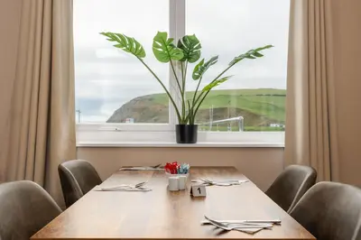 a wooden table with a potted plant on a window at Seacote Hotel in St Bees