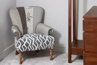 a gray and white chair with a blanket at Keswick Lake Road Apartments in Keswick