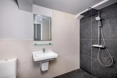 a bathroom with a sink and a toilet and a shower at Keswick Lake Road Apartments in Keswick