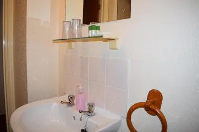 a bathroom with a sink and a mirror at Cragside Guest House in Keswick