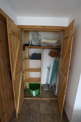 a closet with doors open in a room at Lynton Lodge Studios in Keswick