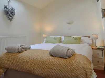 a bedroom with a bed with two pillows on it at Penfold in Dockray