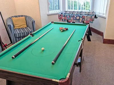 a green pool table in a room with chairs at The Beeches in Bassenthwaite
