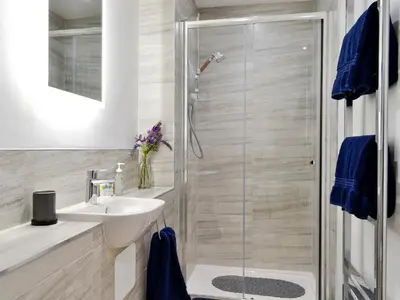 a bathroom with a sink and a shower at 3 Old Posting Stables in Gatehouse of Fleet
