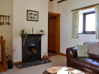 a living room with a couch and a fireplace at Owls Retreat in Whitehaven