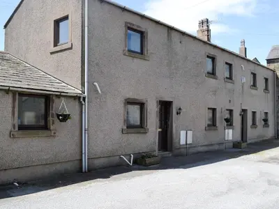 a large brick building with windows and a door at Owls Retreat in Whitehaven