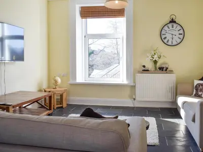 a living room with a couch and a window at Lake Road Heights in Keswick