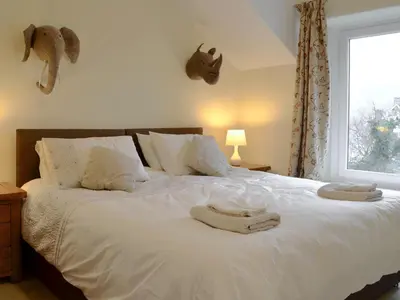 a bedroom with a bed with two towels on it at Lake Road Heights in Keswick