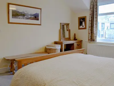 a bedroom with a bed and a mirror and a window at Lake Road Heights in Keswick