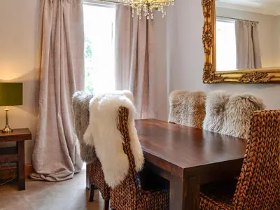 a dining room with a table and a mirror at River View in Dumfries