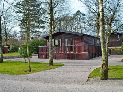 a cabin in a park with trees in front of it at Bransty in Keswick