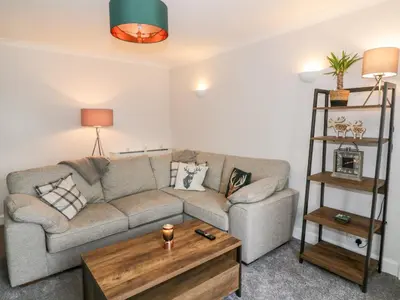a living room with a couch and a coffee table at Ivy Bank in Thornhill