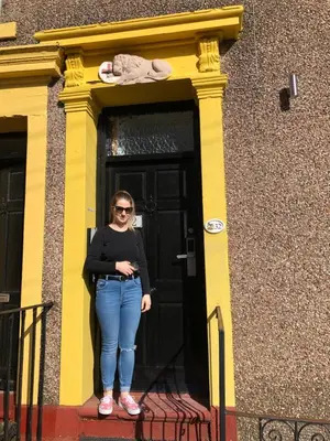 a woman standing in front of a door at Maryport House in Maryport