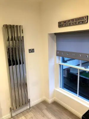 a room with a window and a sign on the wall at Maryport House in Maryport
