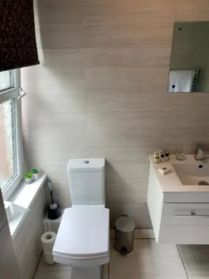 a bathroom with a white toilet and a sink at DOVENBY SHIP in Tallentire