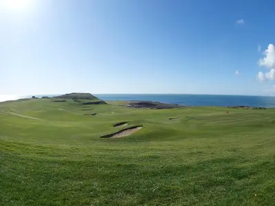 a green golf course with the ocean in the background at Killantrae Burn in Port William