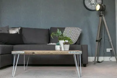 a living room with a couch and a table with plants at Granary Suite No22 - Donnini Apartments in Ayr