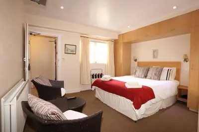 a hotel room with a bed and two chairs at Star Hotel in Kirkcudbright