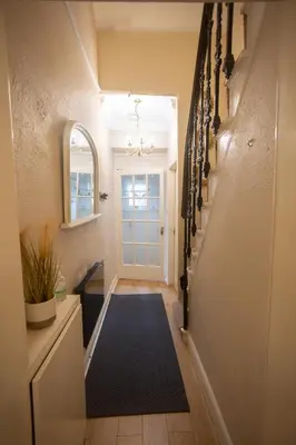a hallway with a blue rug and a white door at Sandgate 2-Bed Apartment in Ayr central location in Ayr