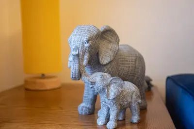 a figurine of two elephants sitting on a table at Sandgate 2-Bed Apartment in Ayr central location in Ayr