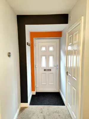 an empty hallway with a white door and orange walls at Carvetii - Phoenix House - Near Hospital, max 8 ppl in Carlisle