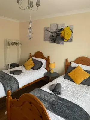 two beds sitting next to each other in a bedroom at Flat 18 in Dumfries