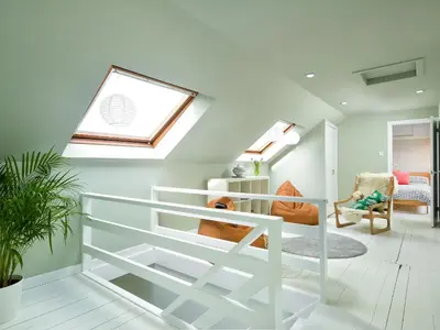 a living room with a skylight and a white staircase at Borgan Cottage in Newton Stewart