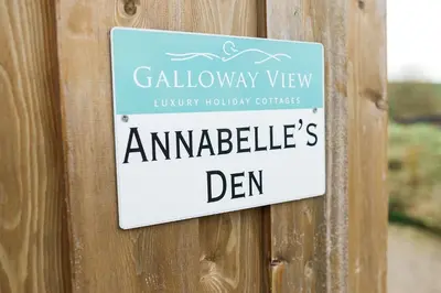 a sign on a wooden door that readsannabies den at Annabelle's Den in Gatehouse of Fleet