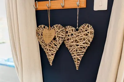 two wooden hearts hanging on a wall at Annabelle's Den in Gatehouse of Fleet