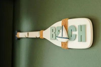 a white bottle with the words rebel hanging on a wall at Beth's Bothy in Gatehouse of Fleet